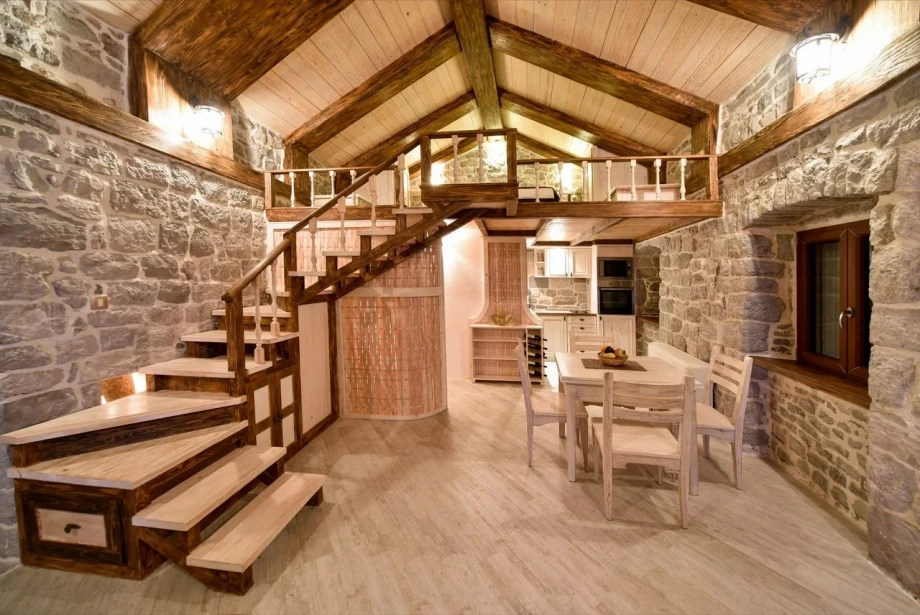 Villa interior with a grand staircase and a white dining table