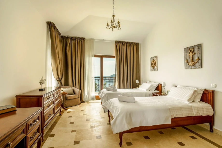 Bedroom with two beds inside a luxurious villa in Budva