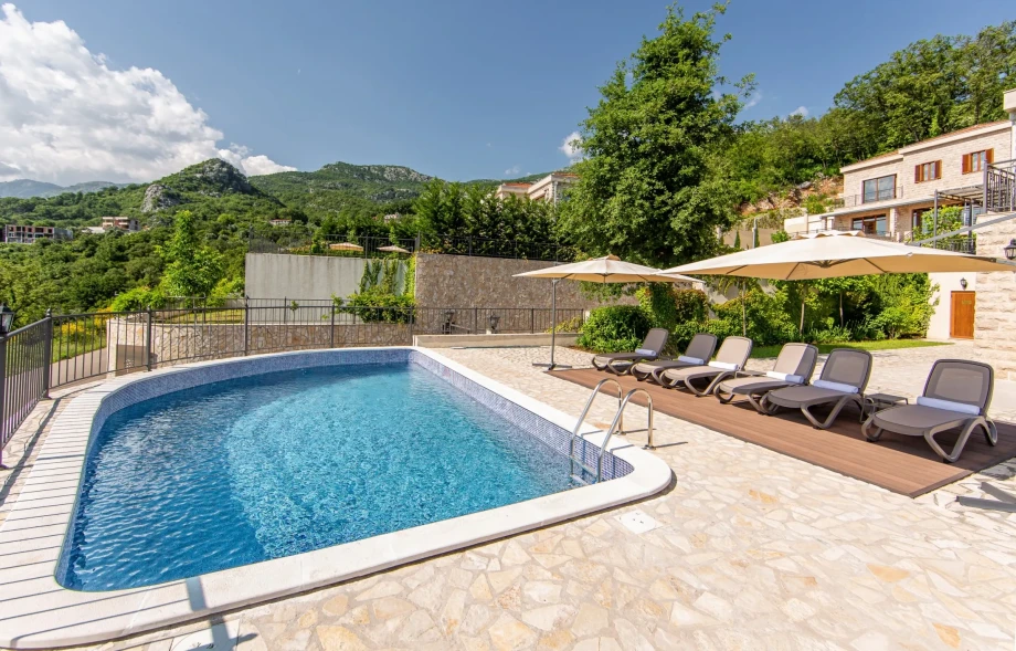 A sunlit swimming pool inside a holiday villa in Montenegro