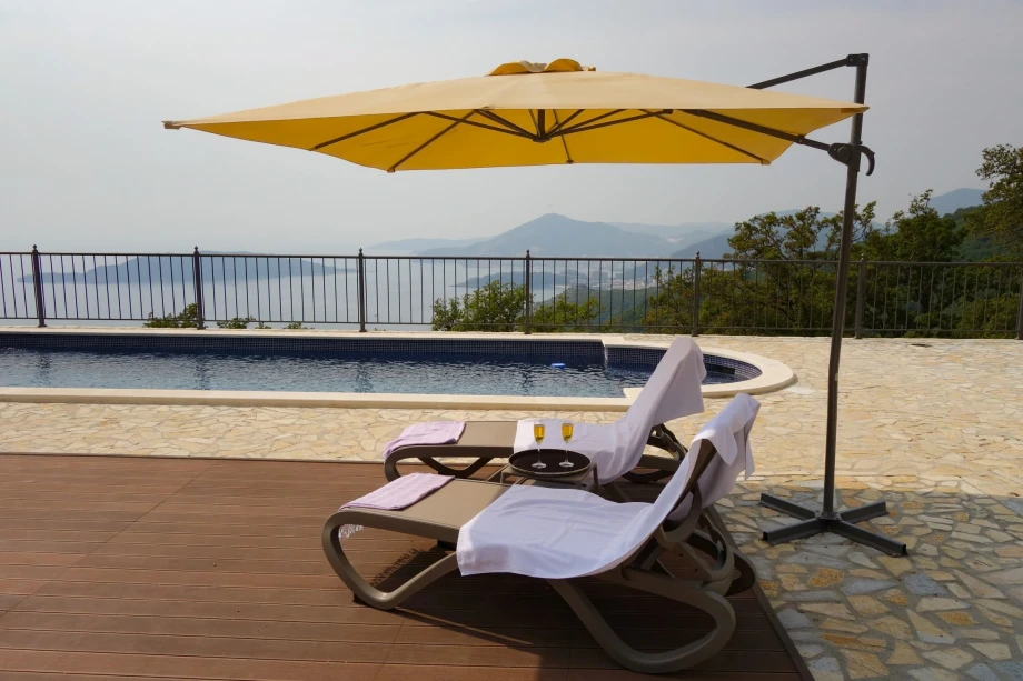 Outdoor pool with deckchairs and mesmerising sights of the Budva Riviera