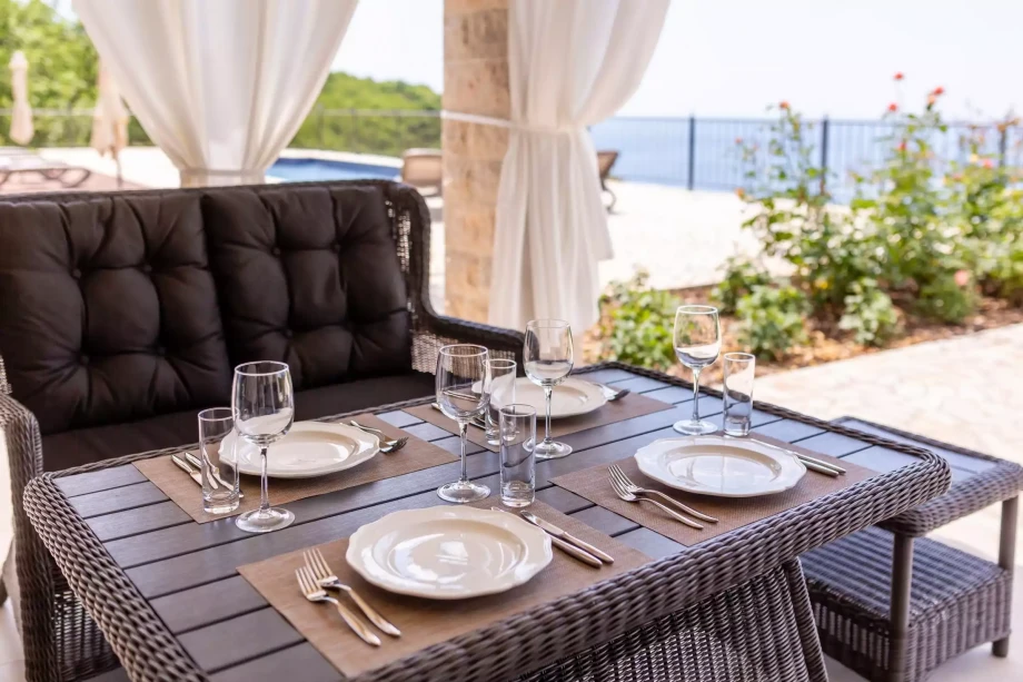 Elegant set for outdoor dining in luxury Villa Reef Tree