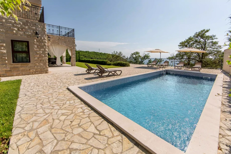 Amazing outside pool with parasols and sunchairs in luxury villa for rent in Montenegro