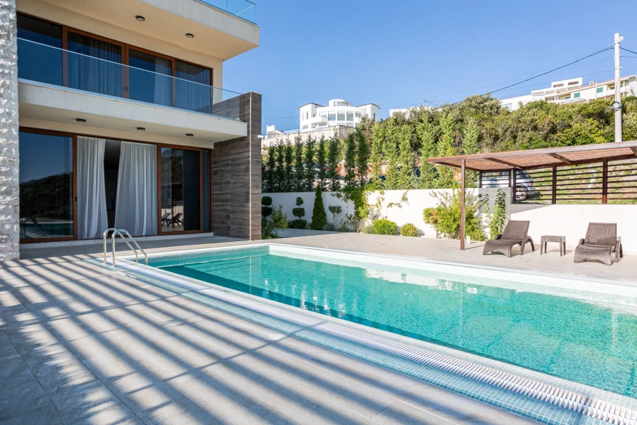 Inviting Outdoor Pool Area with Relaxing Ambience and Lush Surroundings