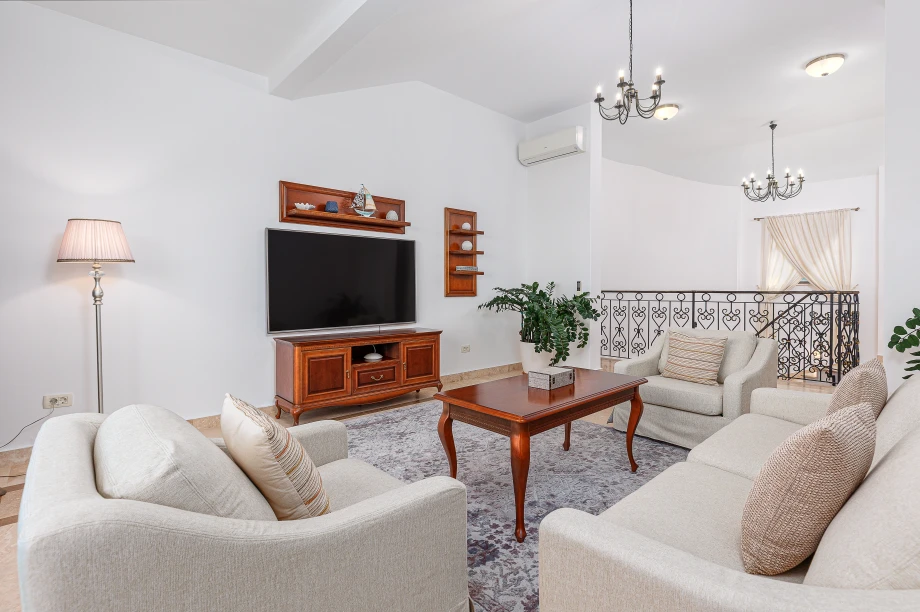 Elegant Family Lounge Featuring Smart TV & Antique-Style Cabinet